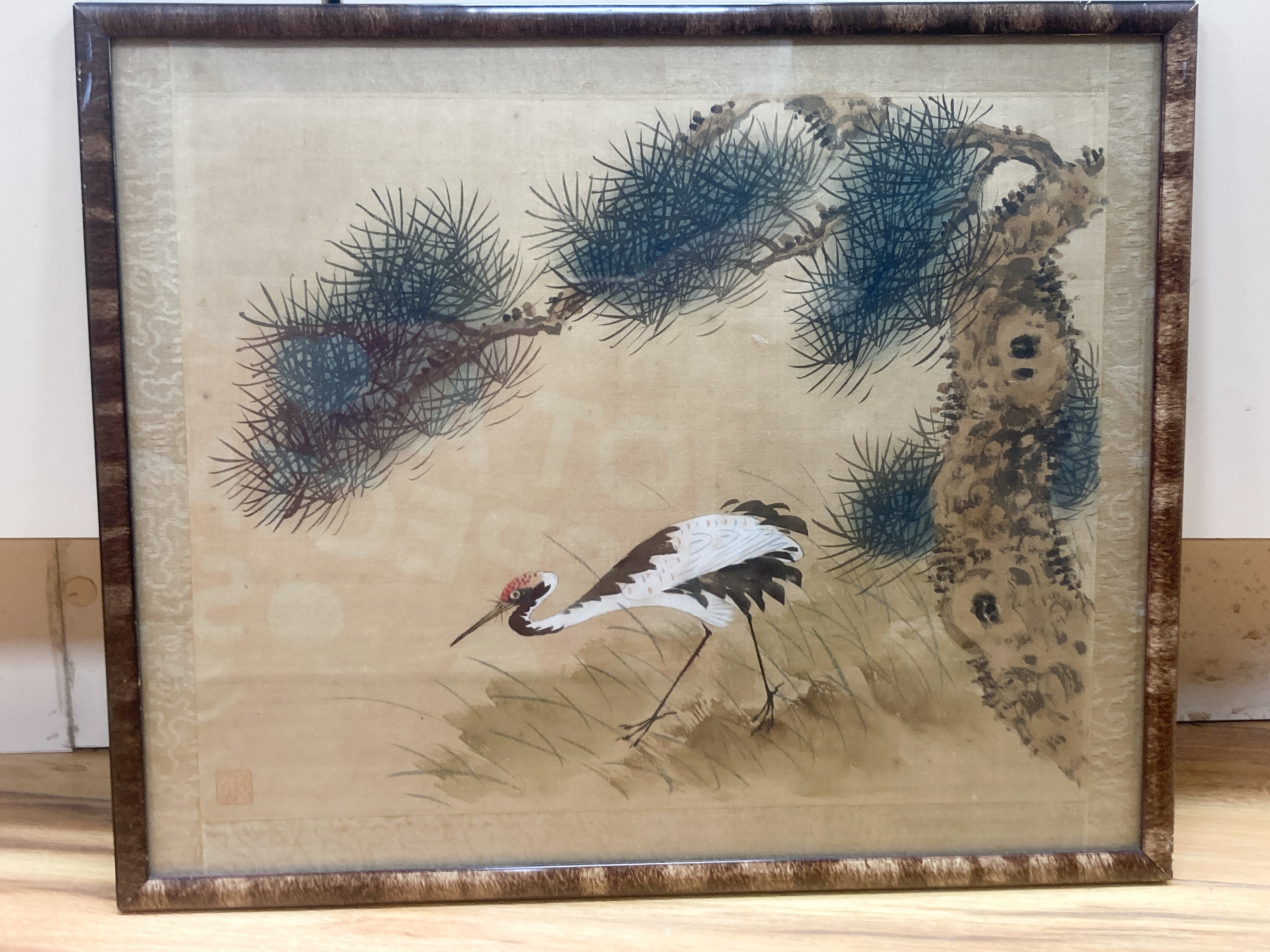 A Chinese watercolour on silk depicting a crane beneath a pin tree, 26 x 36cm with silk border, glazed frame